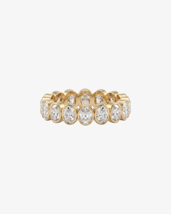 Mostly Fine Rome eternity ring band with oval moissanites in 18K gold vermeil on a white background